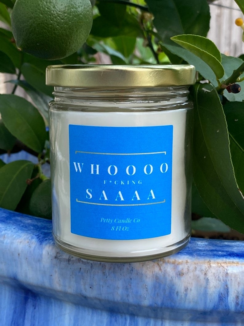 A candle with a label that says whooo fucking saaaa