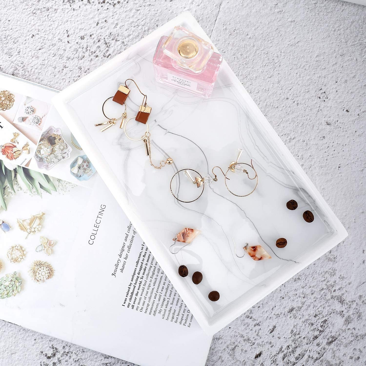 An flatlay of the catch all tray filled with jewelry and coffee beans