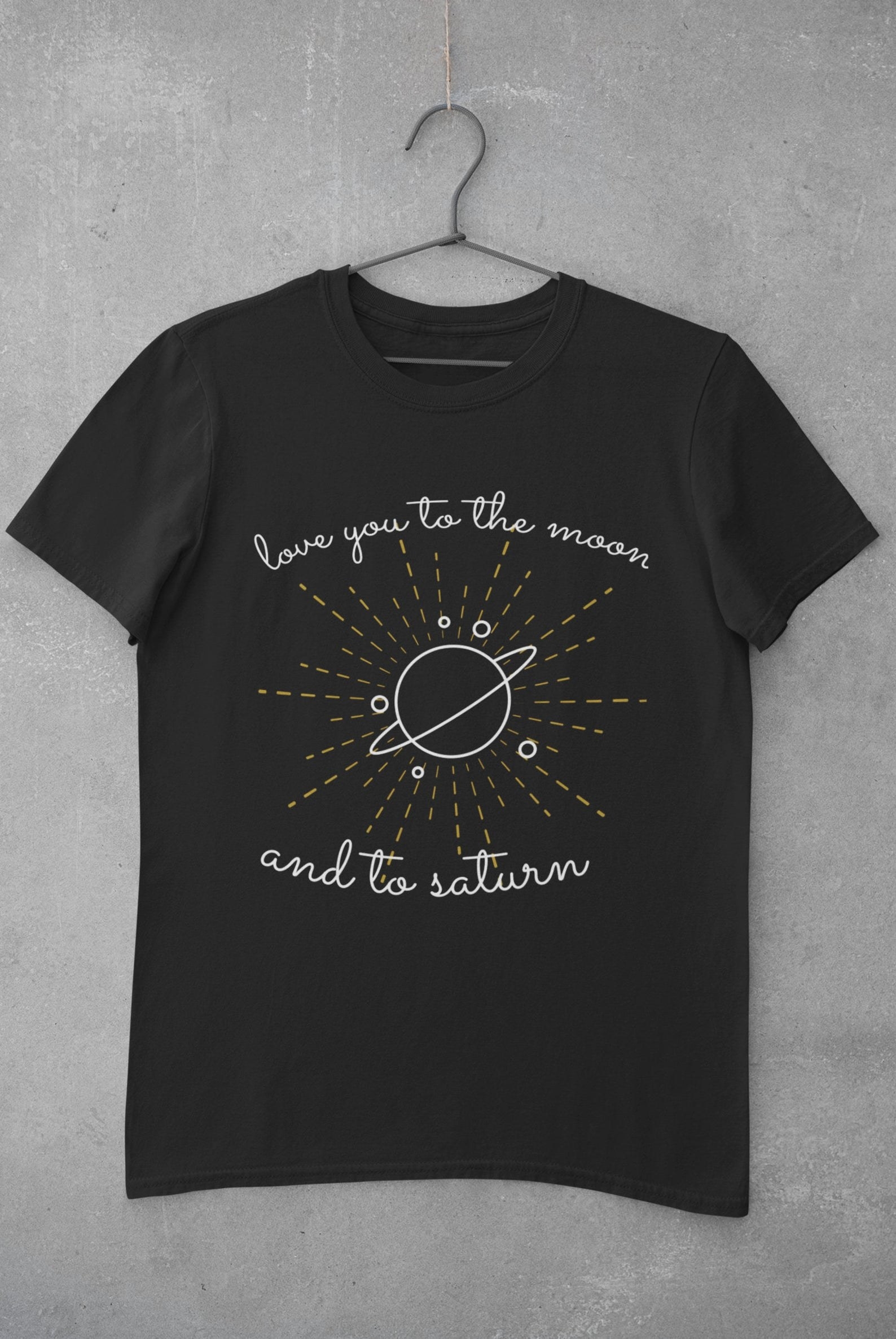a black tee with an illustrations of saturn on it and the lyrics &quot;i love you to the moon and to saturn&quot;