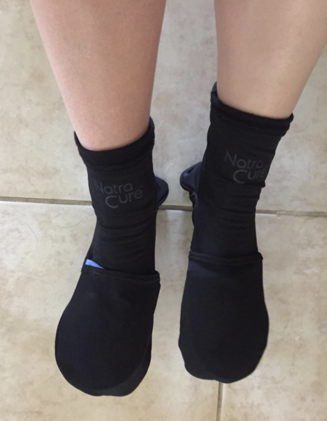 a reviewer wearing the ice pack filled socks in black
