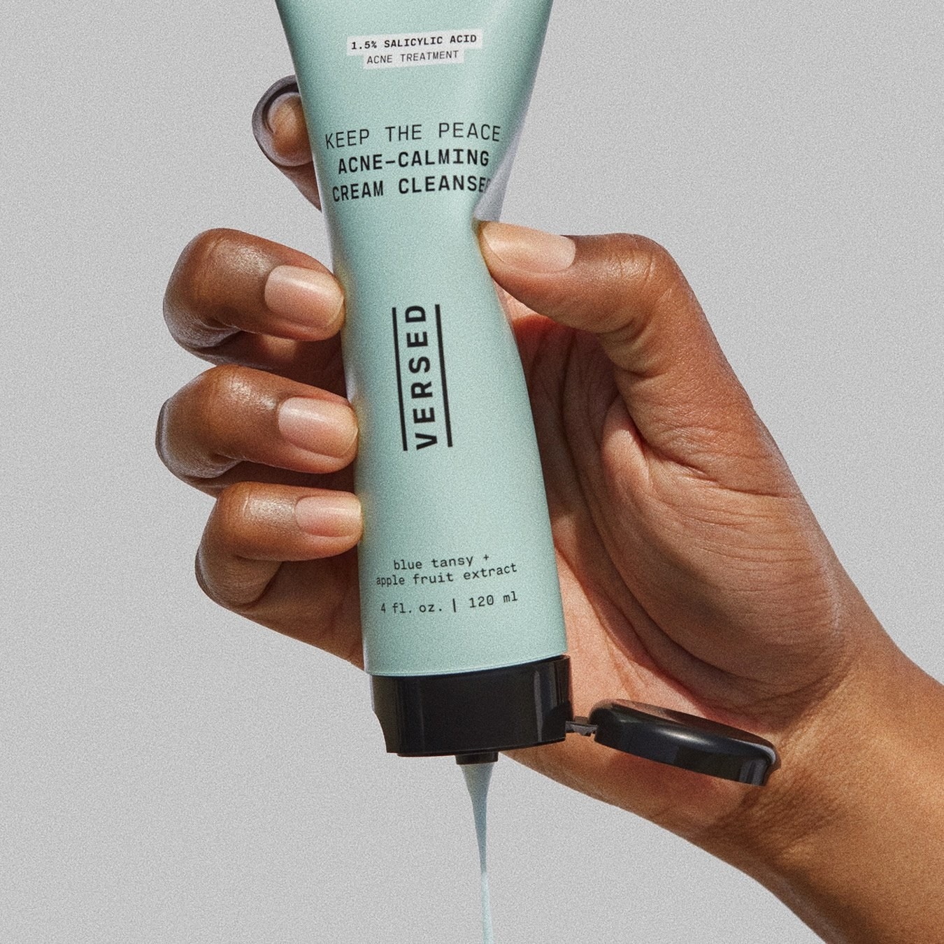 model squeezing tube of blue cleanser