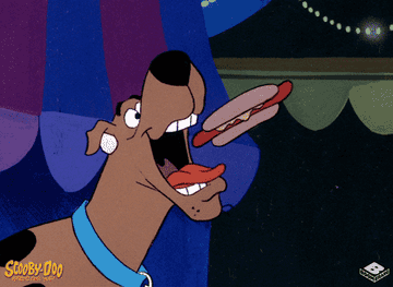 Gif of Scooby from &quot;Scooby-Doo&quot; eating a bunch of hot dogs