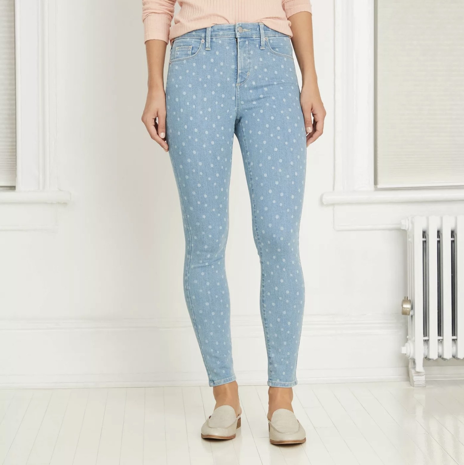 Model wears polka-dot light blue jeans with metallic slides