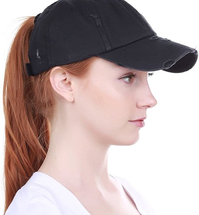 A person wearing the hat with a high ponytail