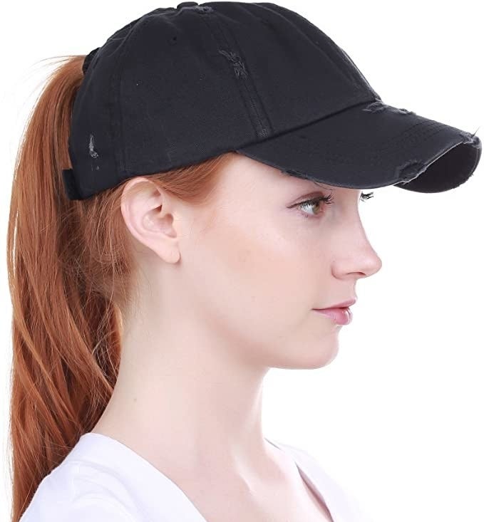 A person wearing the hat with a high ponytail