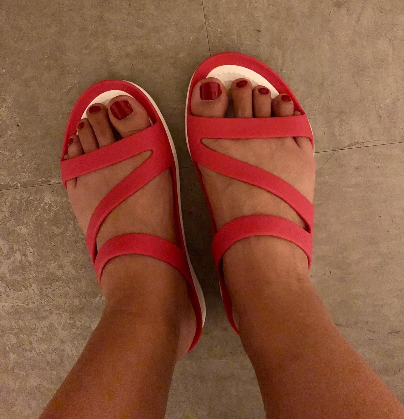 Reviewer wearing the slide sandals in red