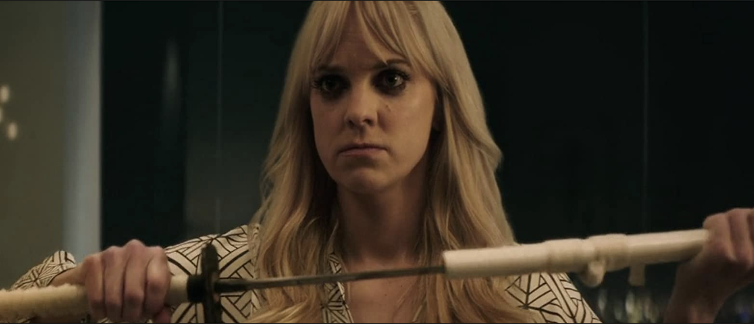 A wild-eyed Anna Farris unsheathing a Japanese sword