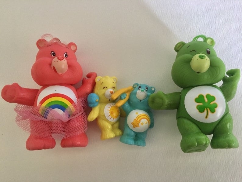 Four different PVC Care Bears figures.