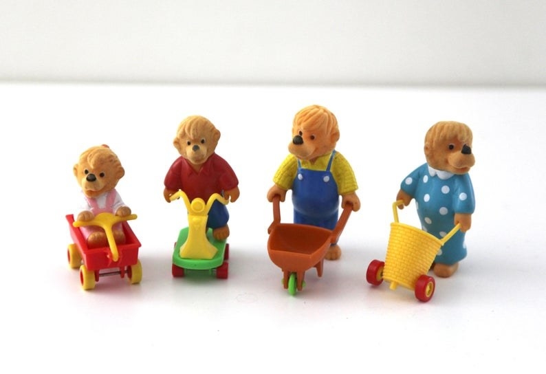 A four Berenstain Bears (Sister, Brother, Papa, and Mama) Happy Meal toys.