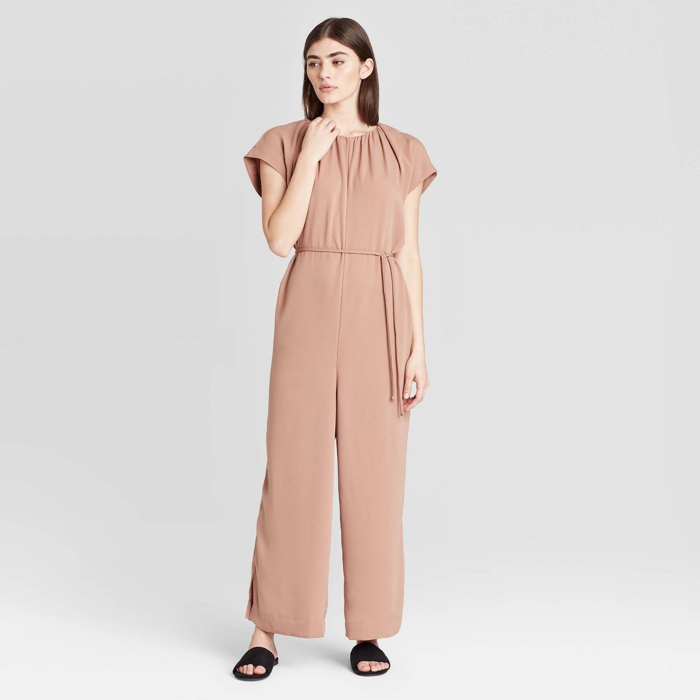 Pale pink cinch-waited jumpsuit with short sleeves and long pants 