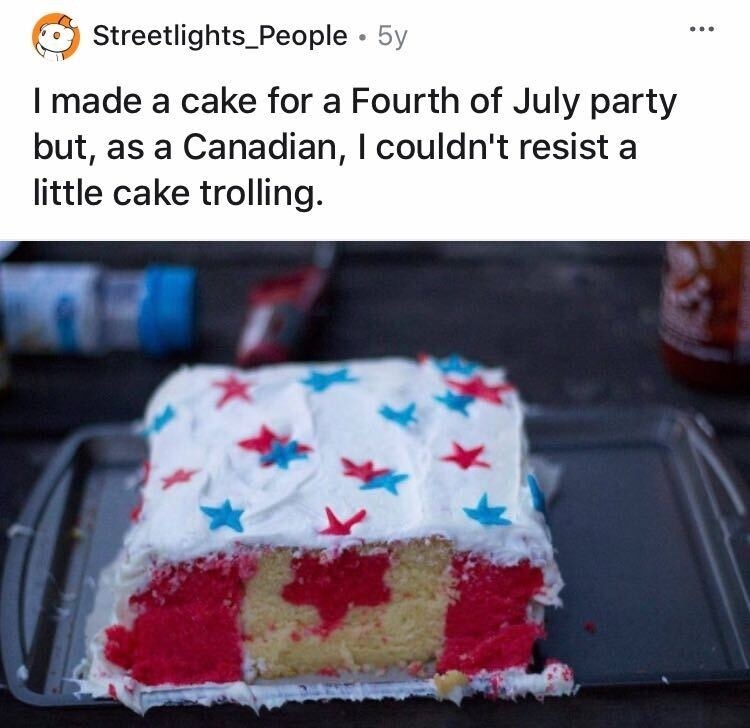 A cake decorated in blue frosting and red and blue stars, but looks like the Canadian flag from the inside