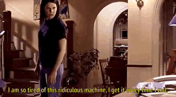A gif from Gilmore Girls showing Lorelai in her living room dressed casually. She approaches the phone and gasps. The caption reads I am so tired of this ridiculous machine, I get it every time I call