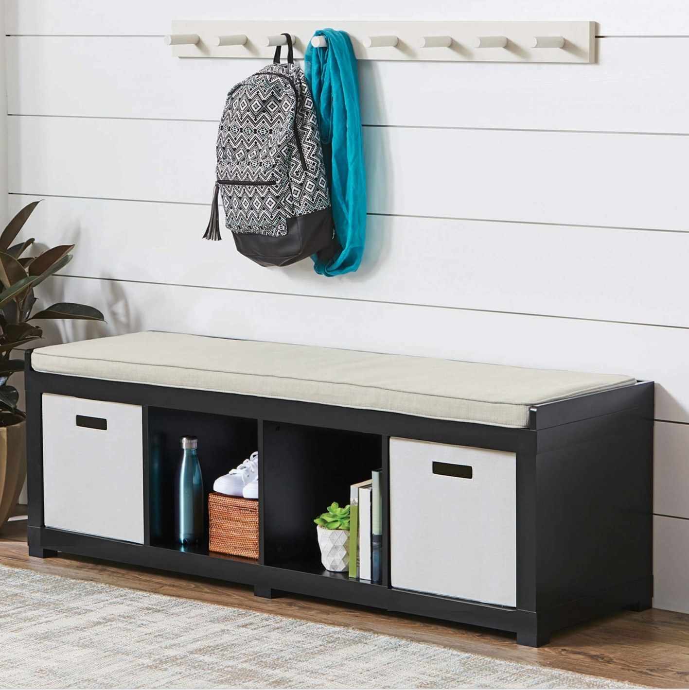 The cushioned bench has four storage cubes