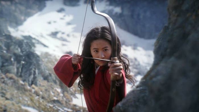 Mulan aiming to shoot someone with a bow and arrow