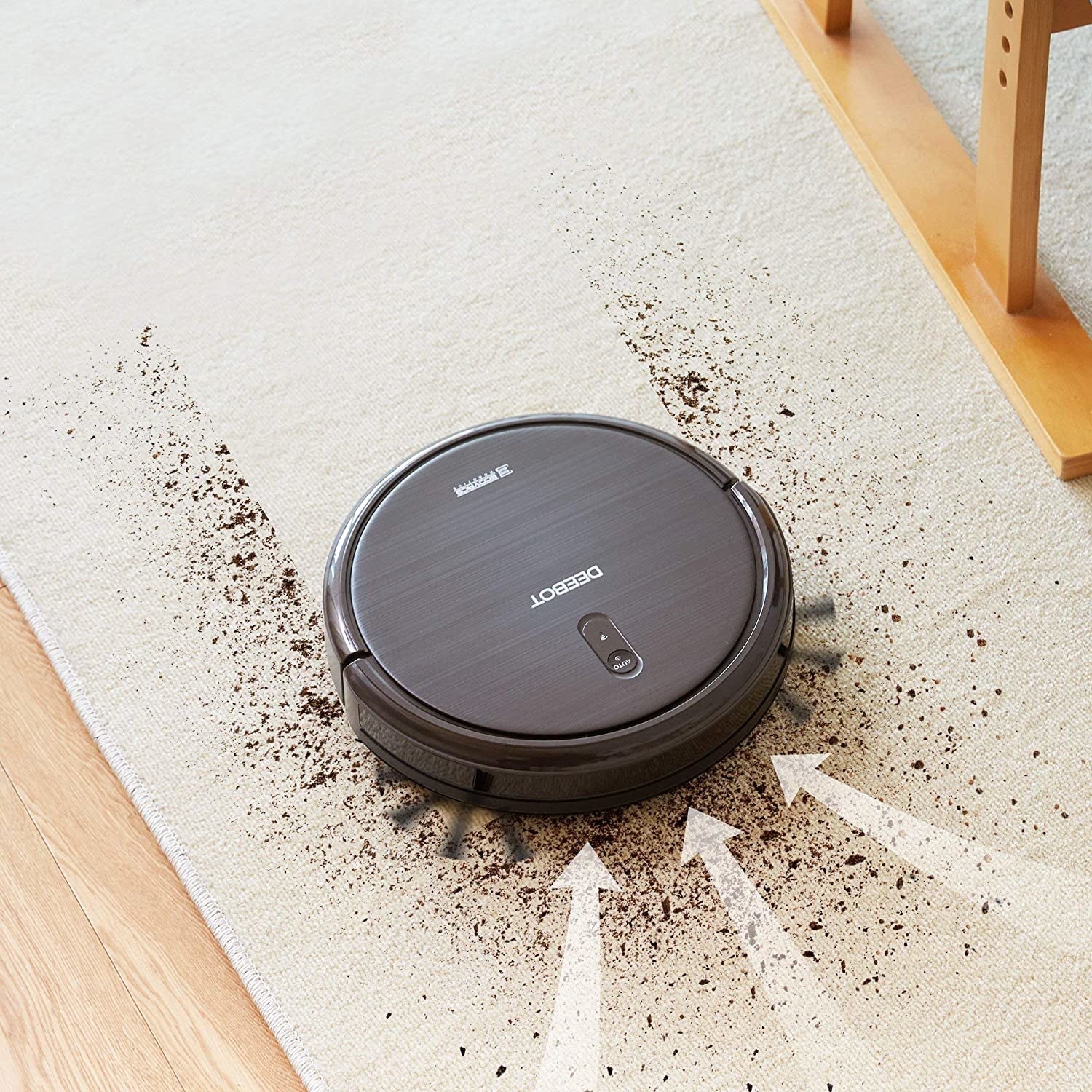 robot vacuum sucking up crumbs on a rug
