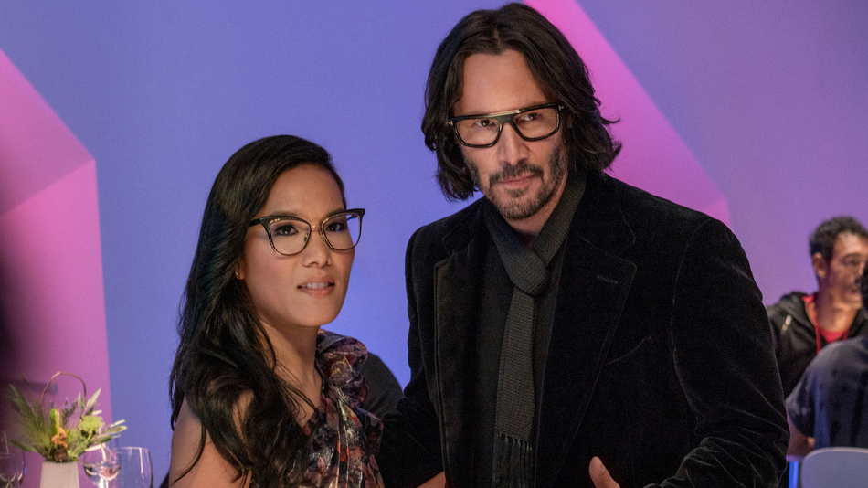 A suave-looking Keanu Reeves stands with a chic Ali Wong
