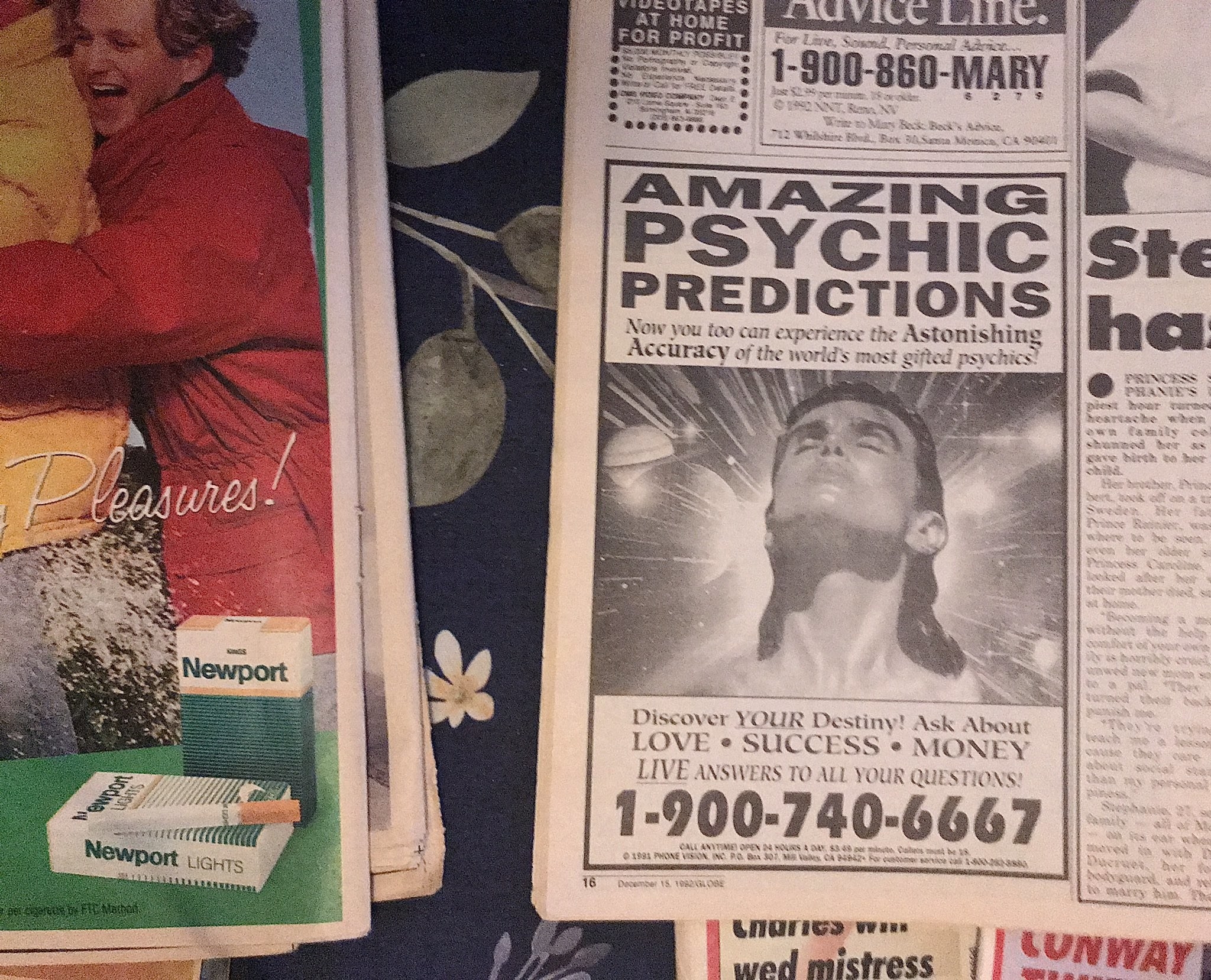 A photo of a psychic advert in an old newspaper which has a man looking up with a picture of space superimposed behind him and reads amazing psychic predictions, discover your destiny and lists an american number
