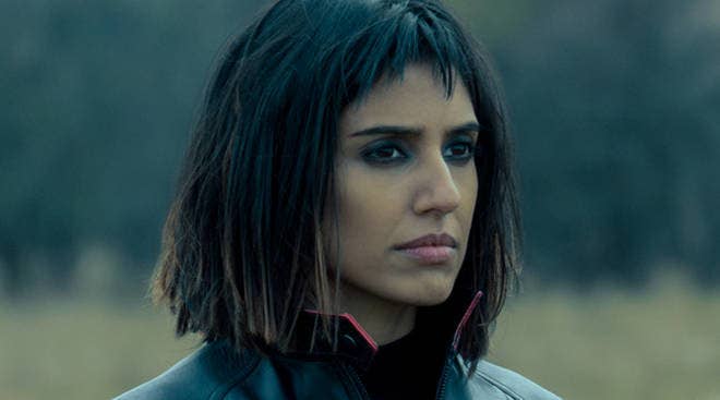 Lila frowns into the distance