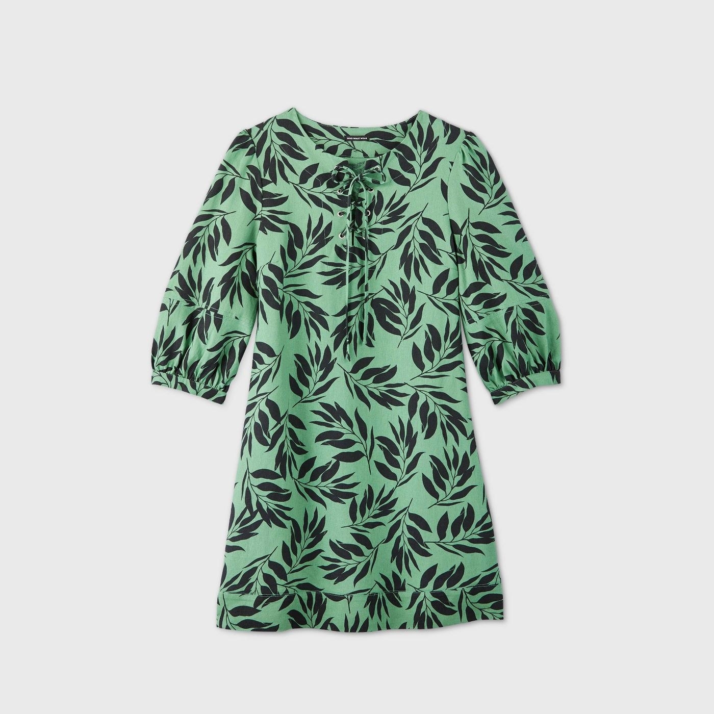 Green dress with navy leaf patterns and a bow at the neckline 