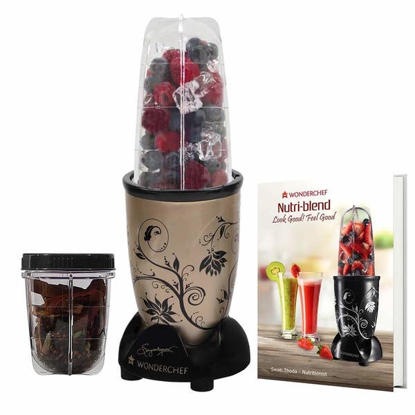 The Nutri-blend pictured with fruits in the blender jar and whole spices in the small grinder jar.