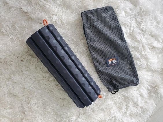 Reviewer's picture of the black foam roller with its slipcover