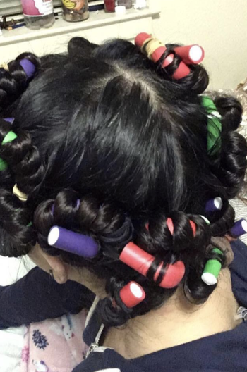 Reviewer using the foam rods in hair