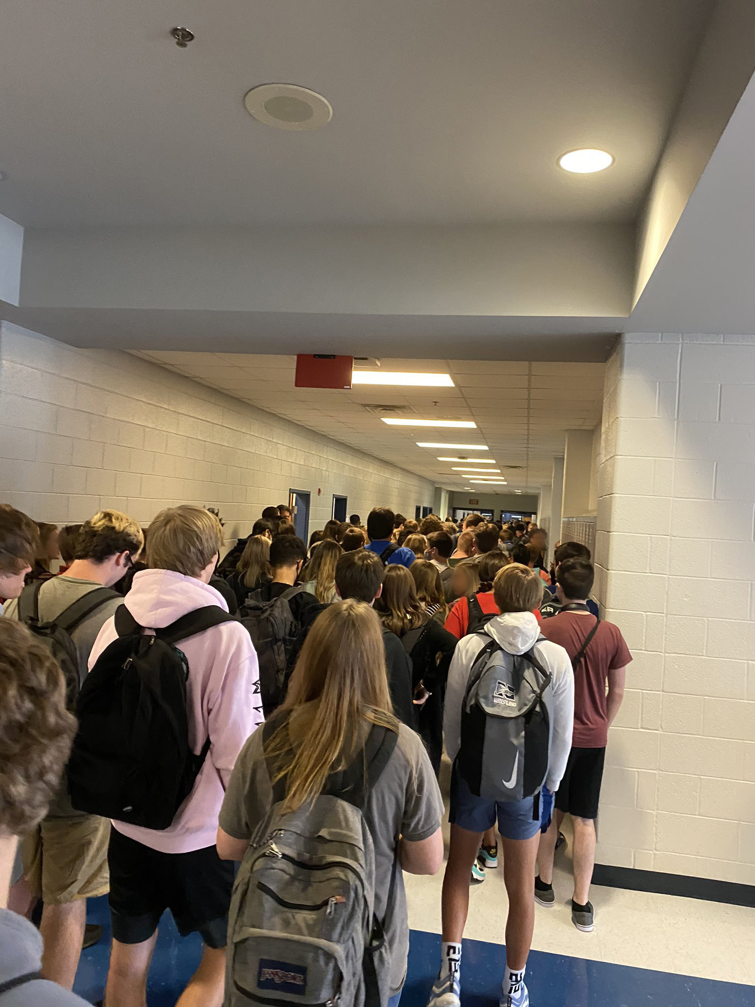 Students are packed into a school hallway