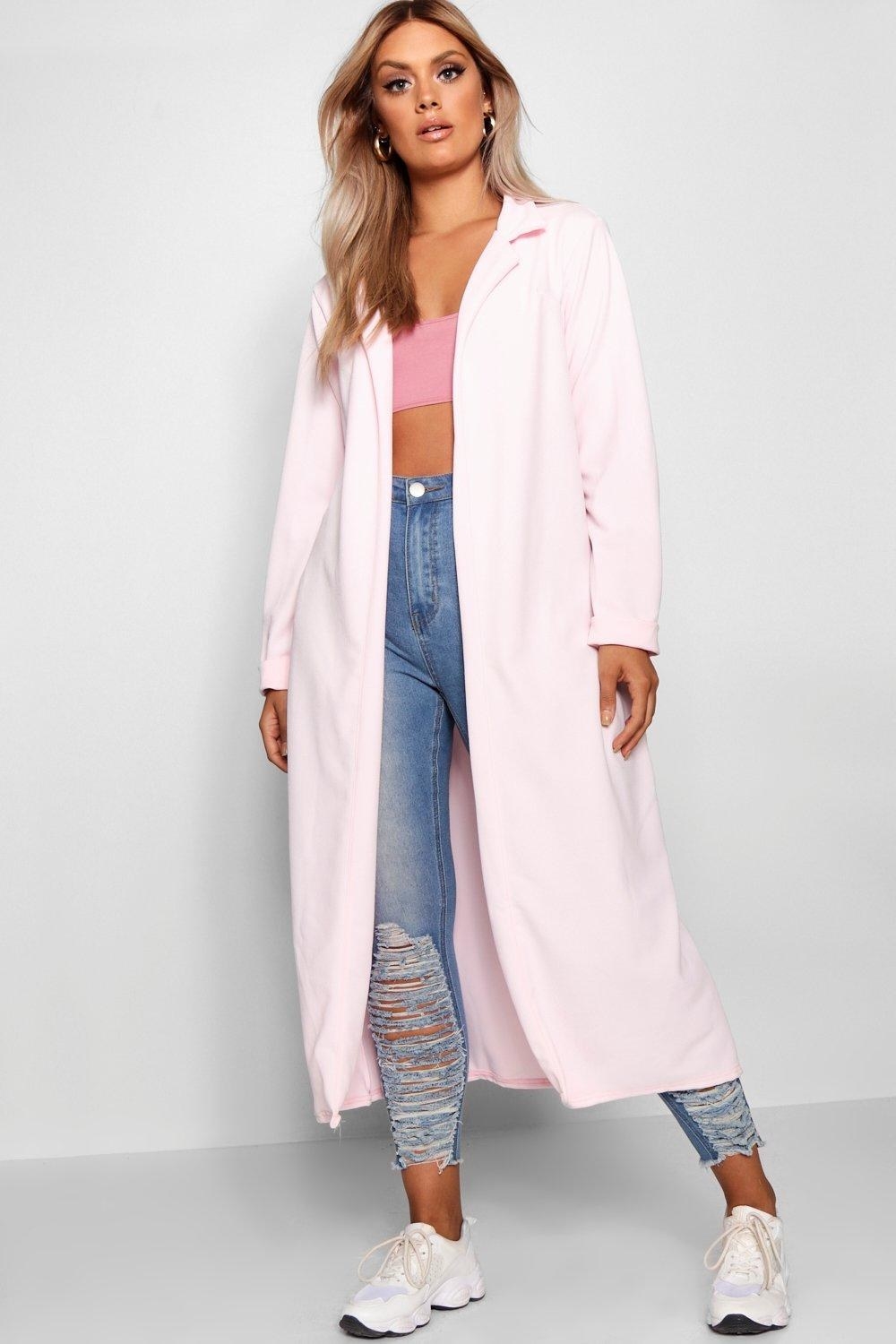 A model wearing the pale pink open duster, which hits at their calves