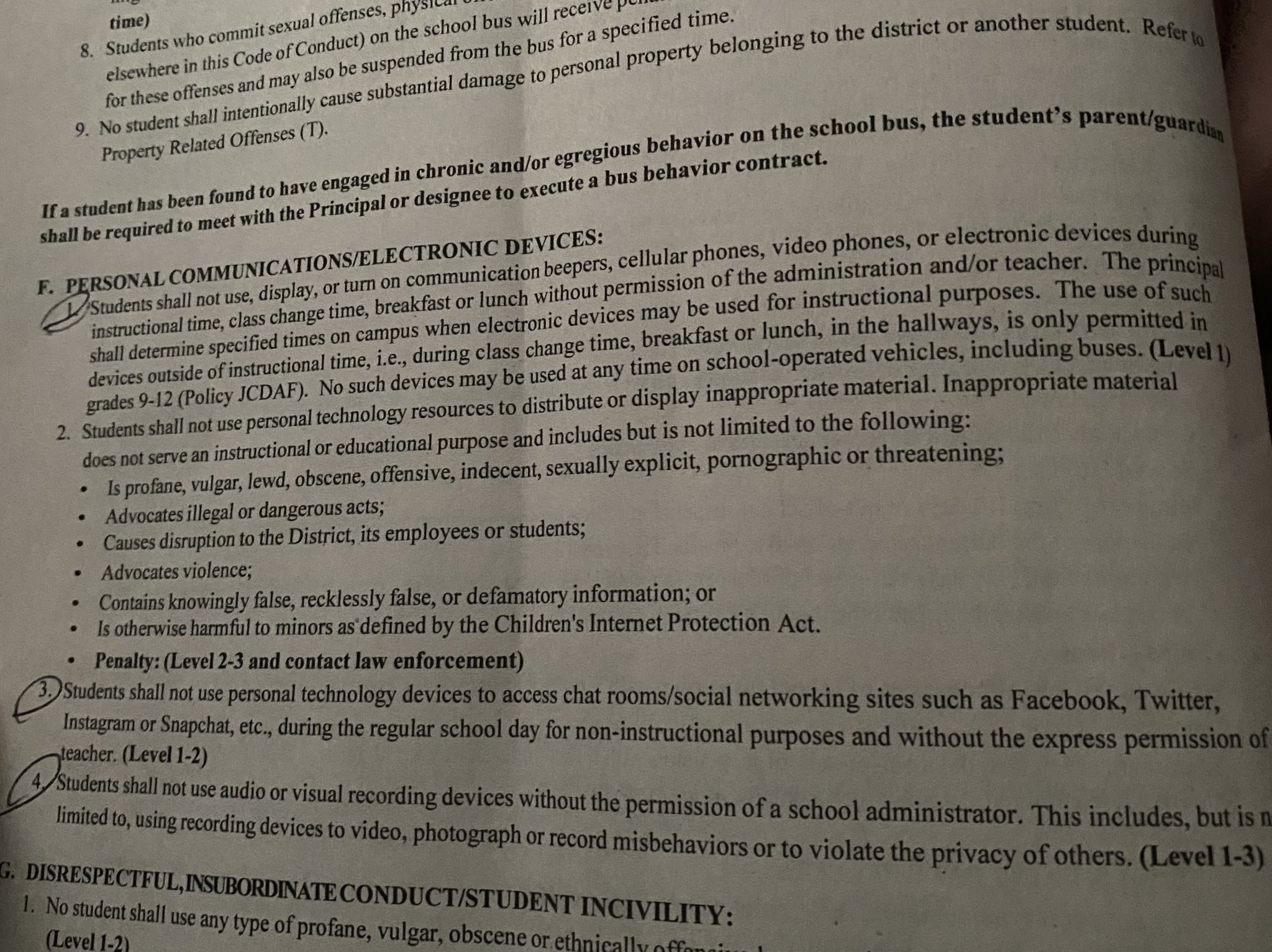 The code of conduct with rules circled stating that students cannot use cellphones while at school and cannot access social networking sites