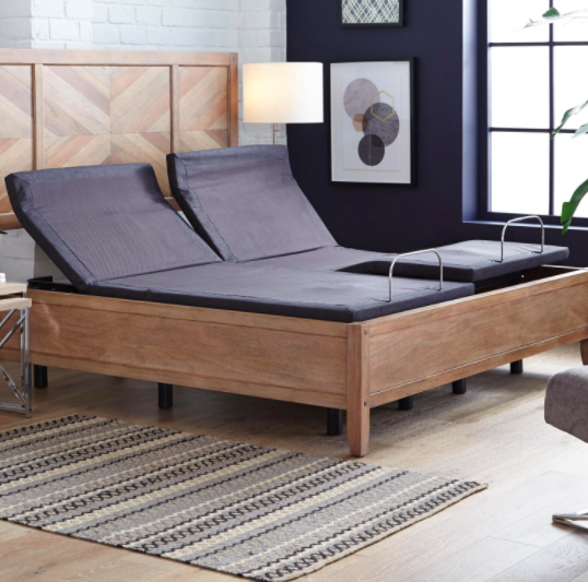 Brown adjustable bed base on a king-sized hardwood bed