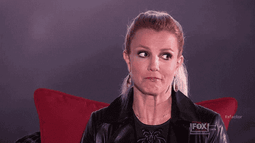 Britney Spears, the queen of iconic reactions, looks away awkwardly