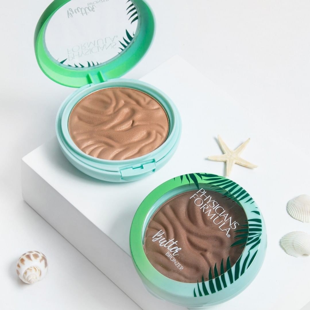 Two bronzers artfully arranged on a pale background with seashells