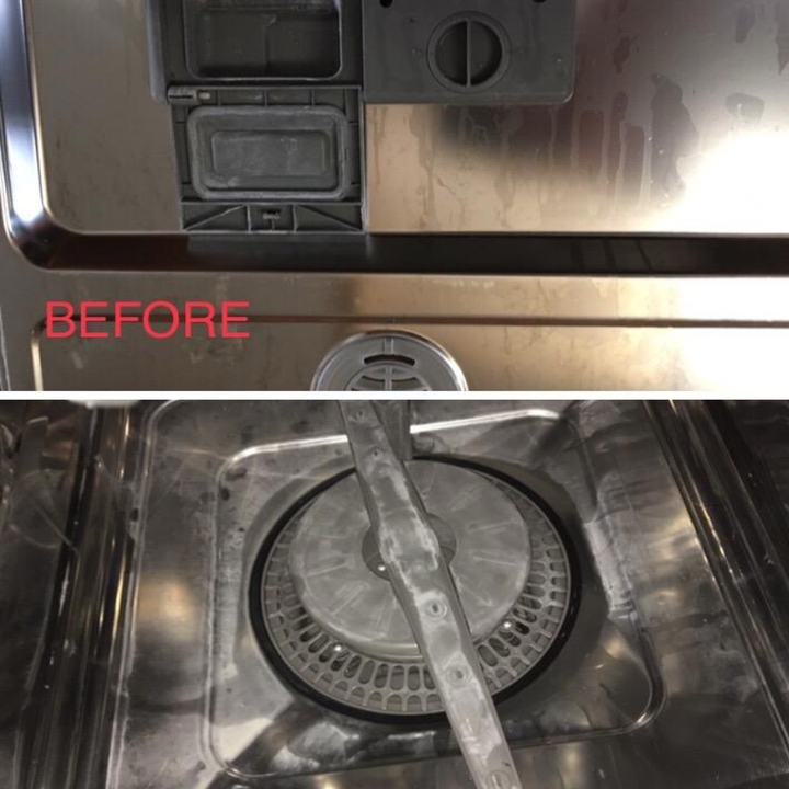 A dirty dishwasher door and inside filled with scum and grime