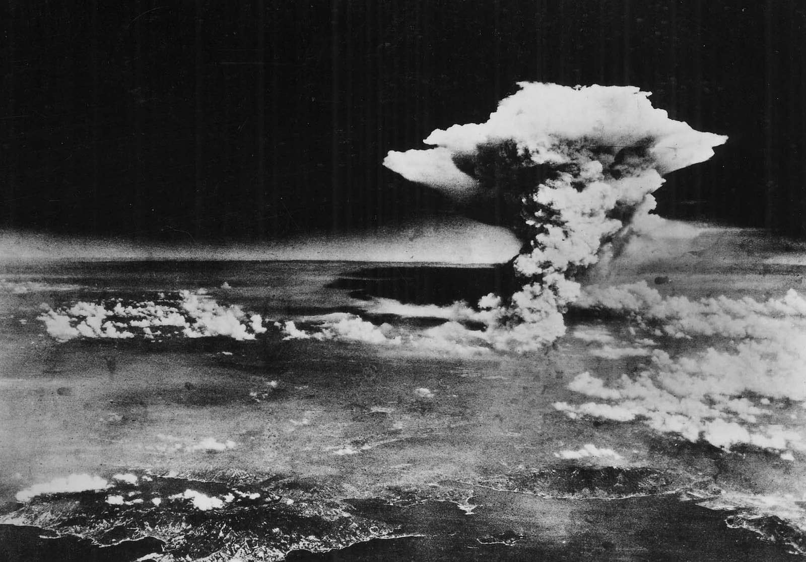 A mushroom cloud seen from the air over the city of Hiroshima 