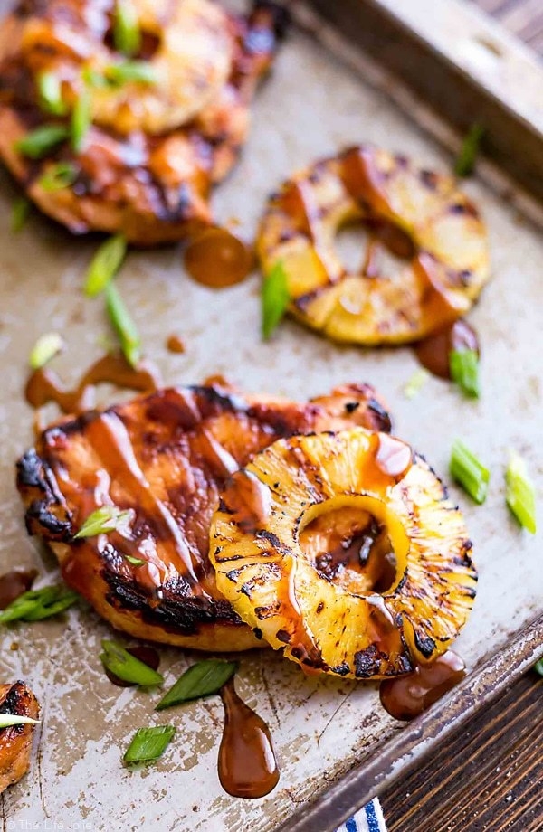 Barbecued pork chops in a sweet barbecue glaze with a grilled pineapple ring on top.