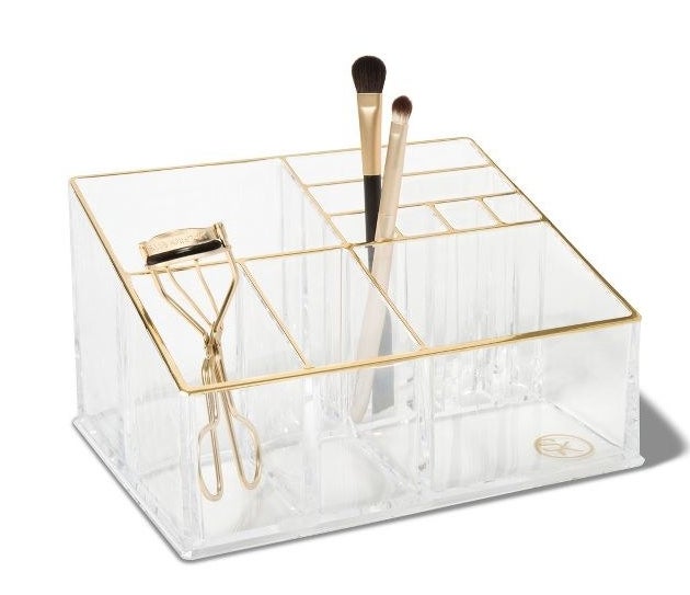 The clear organizer with gold trim and two large, two medium, two small, and four extra small compartments