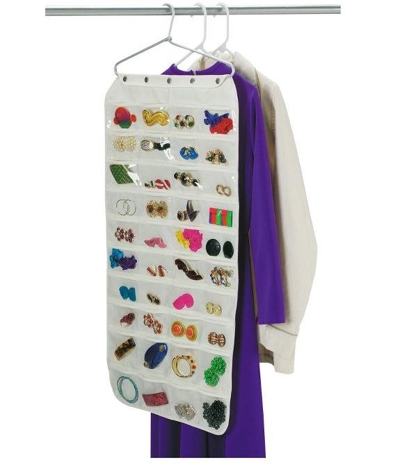 The white organizer on a hanger hung next to clothes