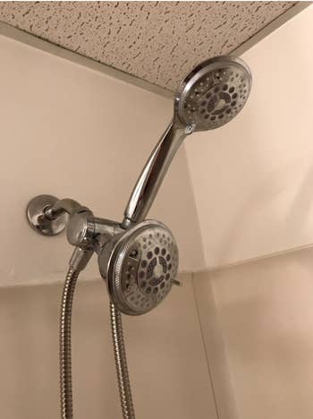 A reviewer's installed dual shower head that shows each head with multiple spray options