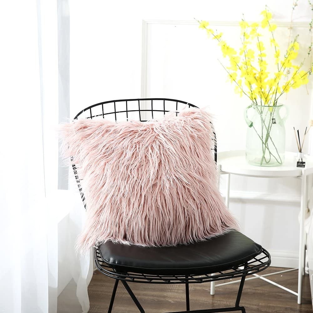 A faux fur pillow on an office chair
