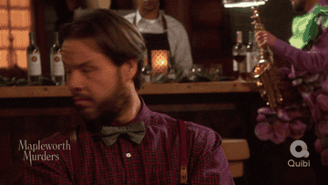 Ike Barinholtz in suspenders and a bow tie.