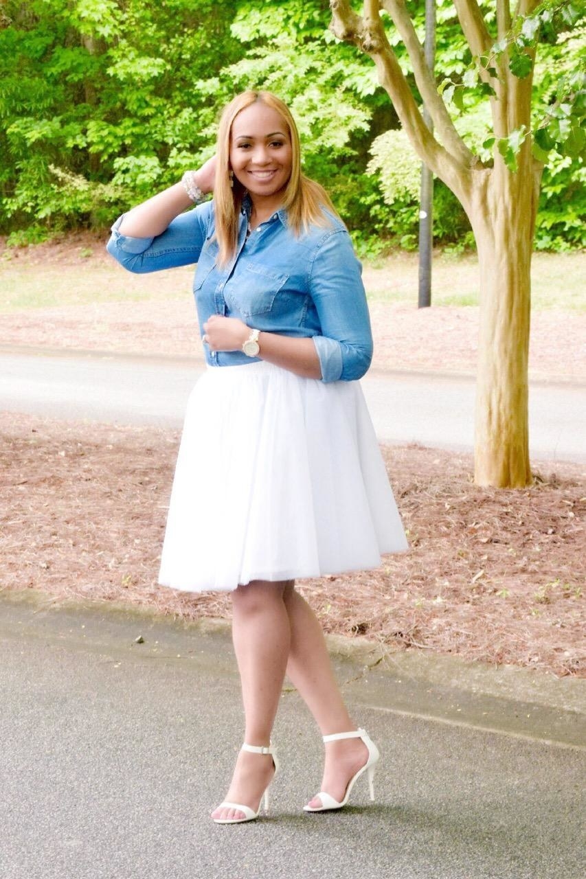 reviewer in white knee-length tulle skirt