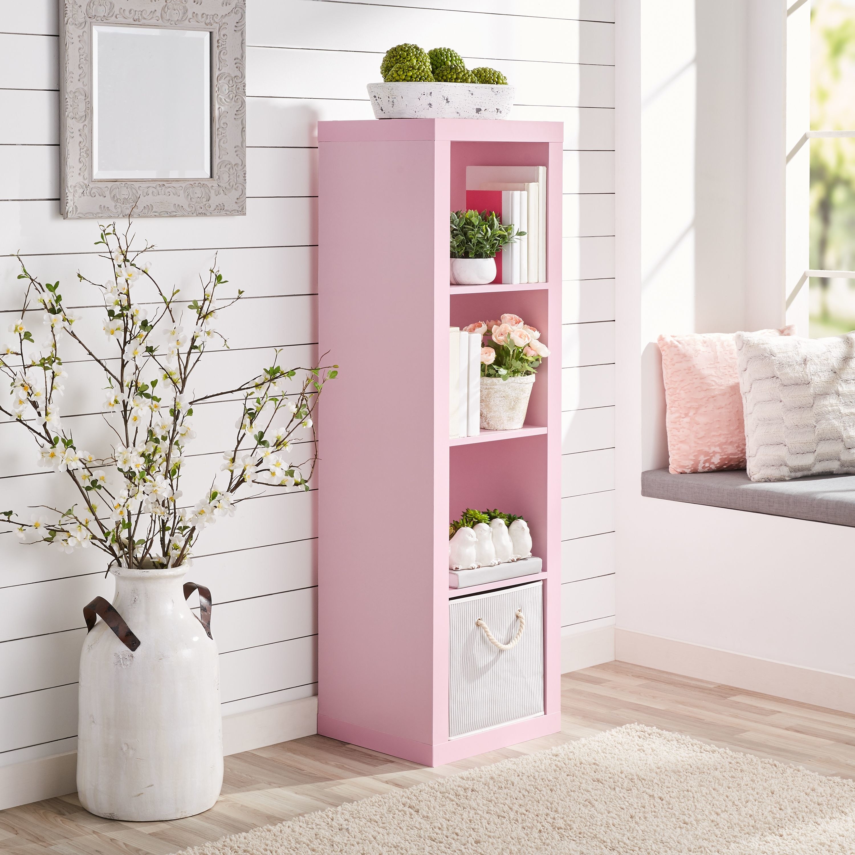 The shelving unit in pink, which has four compartments 