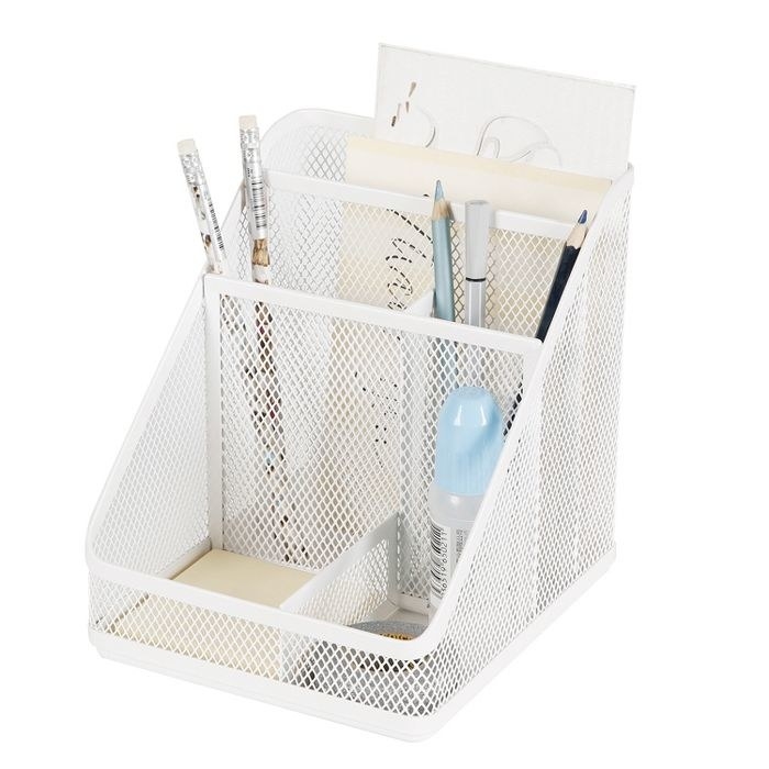The white wire organizer with slots for writing utensils, small papers, sticky notes, and small items