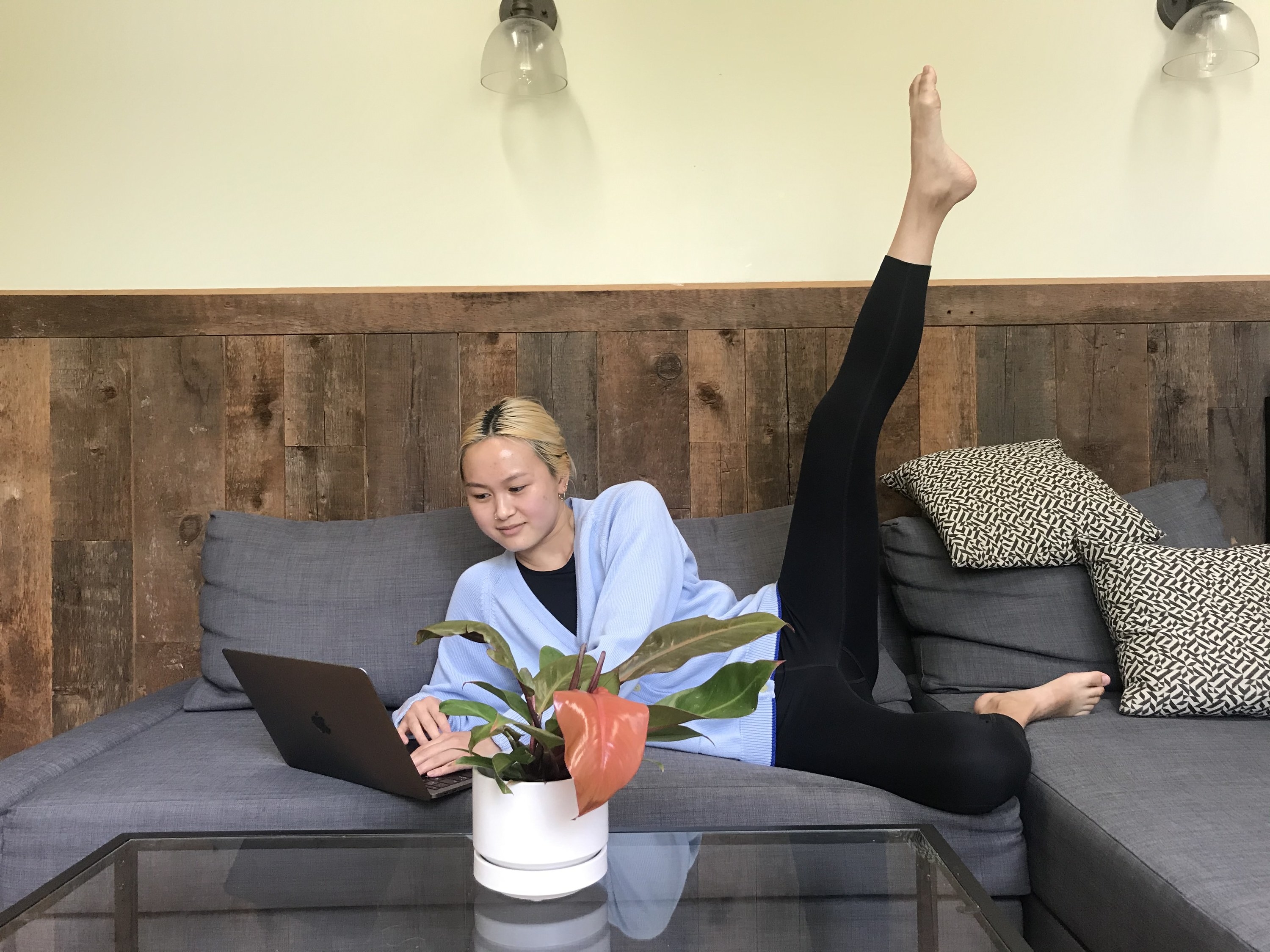 BuzzFeed editor wearing the leggings on her couch