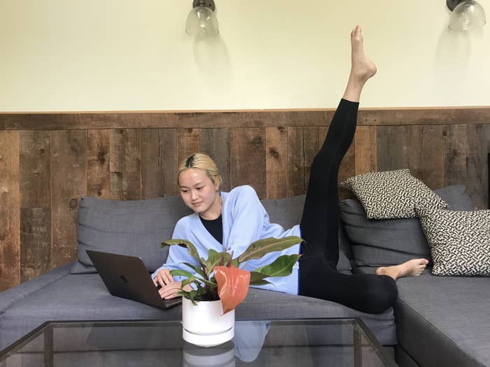 BuzzFeed editor wearing the leggings on her couch