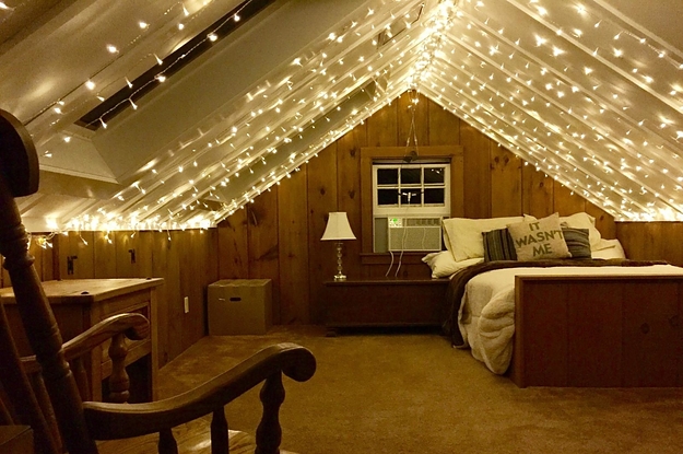 a room whose peaked ceiling is covered in string light curtains