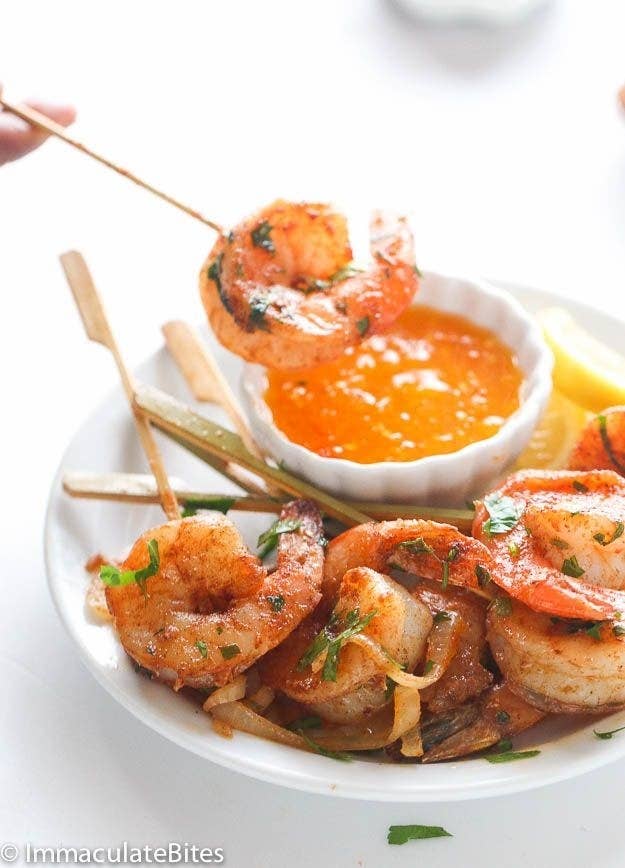 Images of Jamaican jerk shrimp on skewers with a fruity pepper dipping sauce