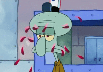 Squidward has a blank stare while Spongebob throws pink flower petals into his face
