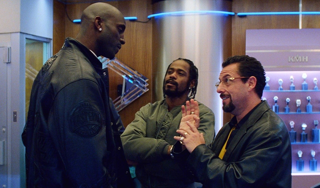 Kevin Garnett talking to Adam Sandler as Howard, alongside Lakeith Stanfield as Demany in Uncut Gems