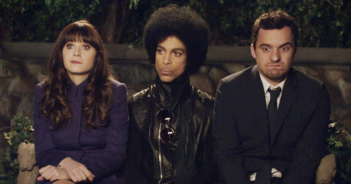 Zooey Deschanel as Jessica and Jake Johnson as Nick Miller sitting next to Prince in New Girl